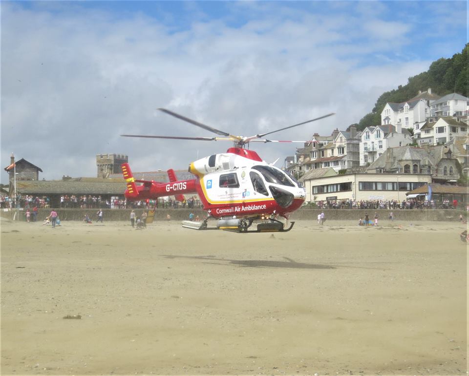 Pic 1 Cornwall Air Ambulance lands on Looe beach this summer. Credit Richard Davies