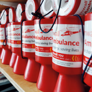 Cornwall Air Ambulance money jars organised on a shelf