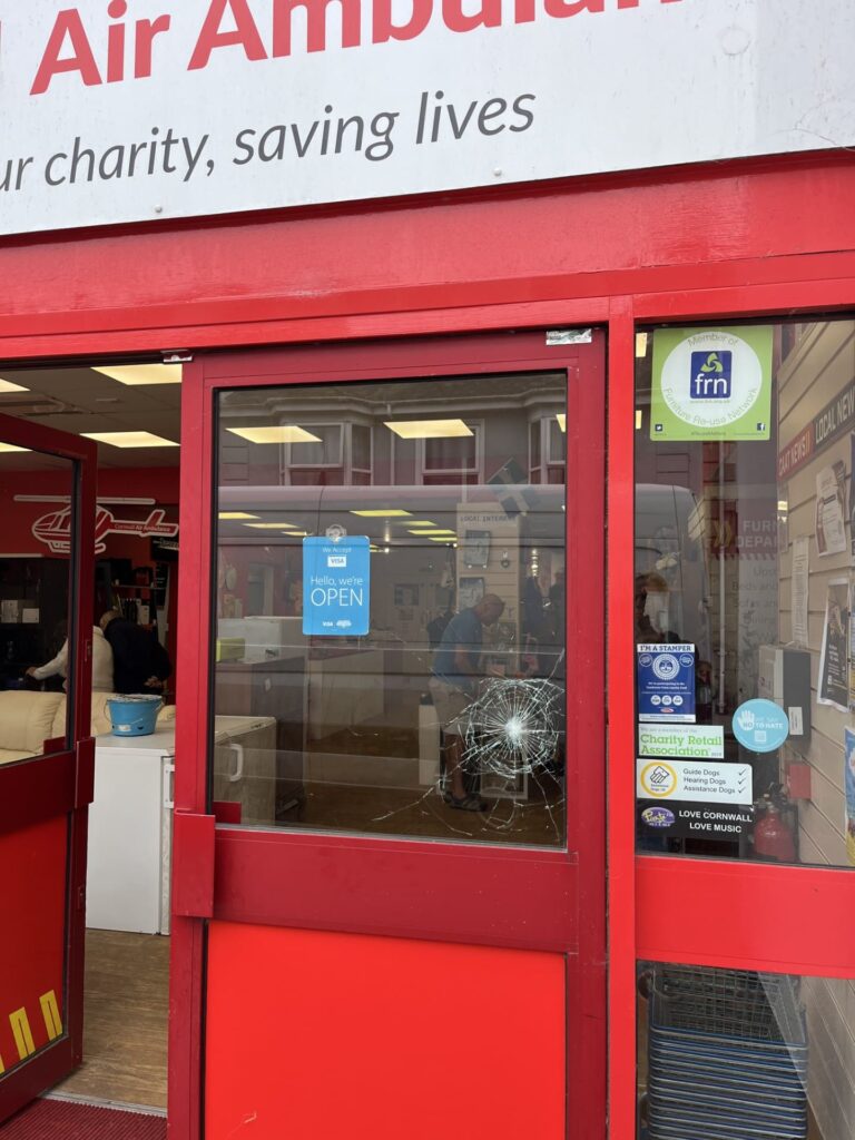 Smashed window on the glass door in Cornwall Air Ambulance's Camborne based charity shop.