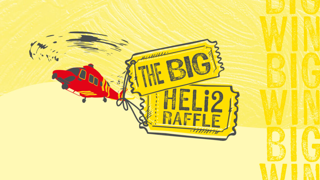 Illustration of the Cornwall Air Ambulance helicopter pulling two large raffle tickets in the sky that say 'The Big' & 'Heli2 Raffle.'
