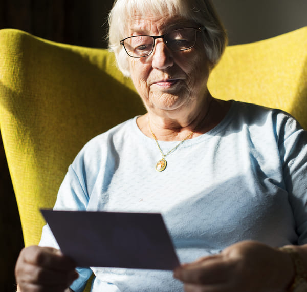 Woman looking at a photo of past relative