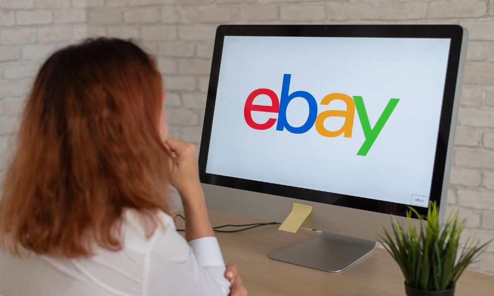 A female volunteer jogging onto ebay on a computer screen.