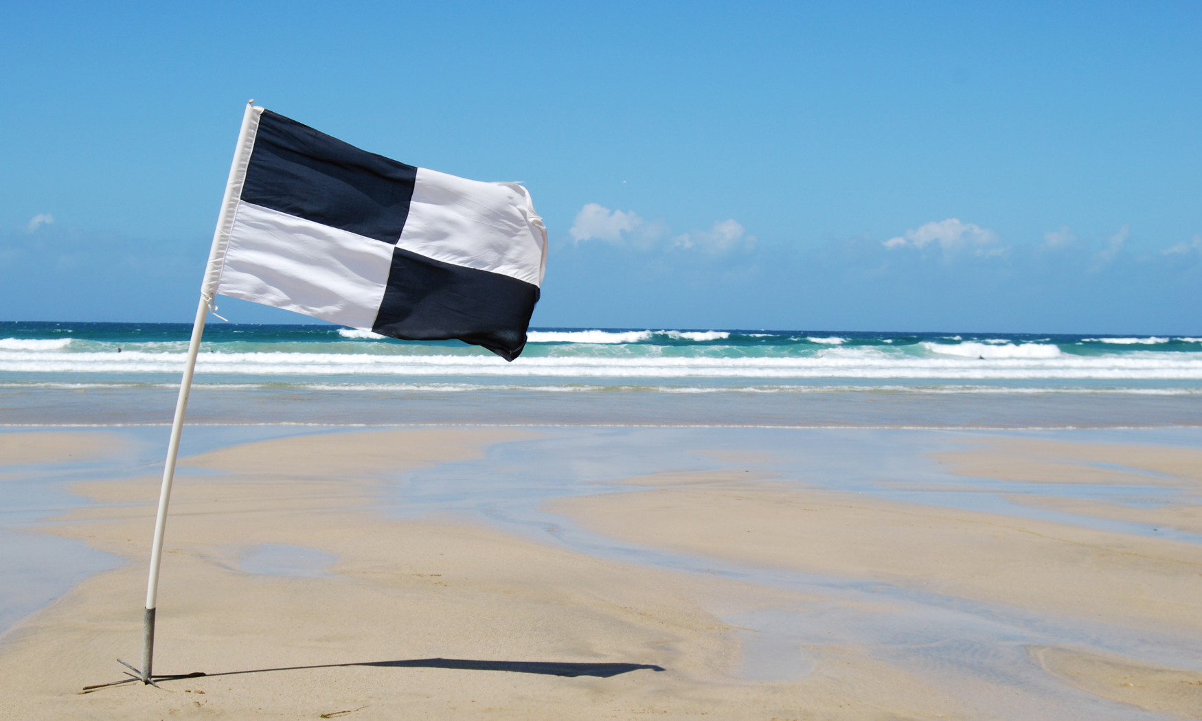 Black and white flags to stay safe on the beach