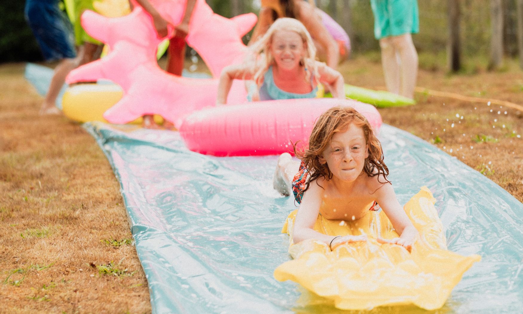 Kids Having Fun on a Slip and Slide